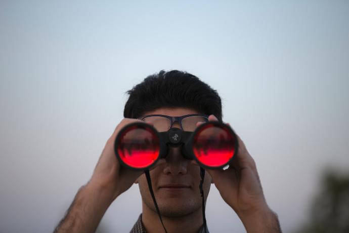 person holding black binoculars